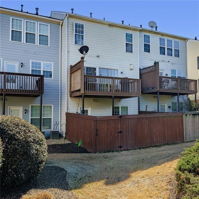 back of house featuring fence