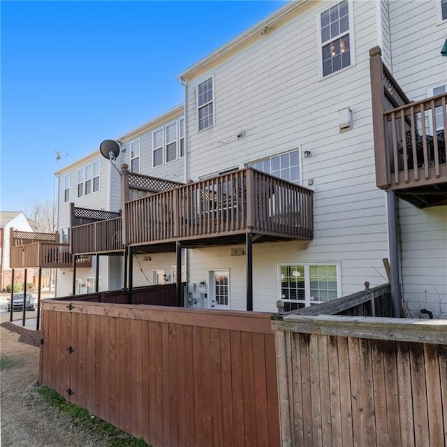 back of property with fence and a residential view