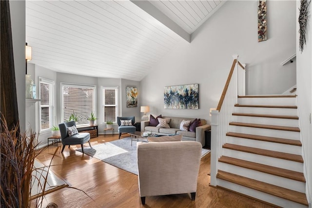 living room with vaulted ceiling, hardwood / wood-style floors, and wooden ceiling