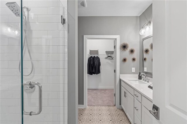 bathroom featuring tile patterned floors, vanity, and a shower with shower door