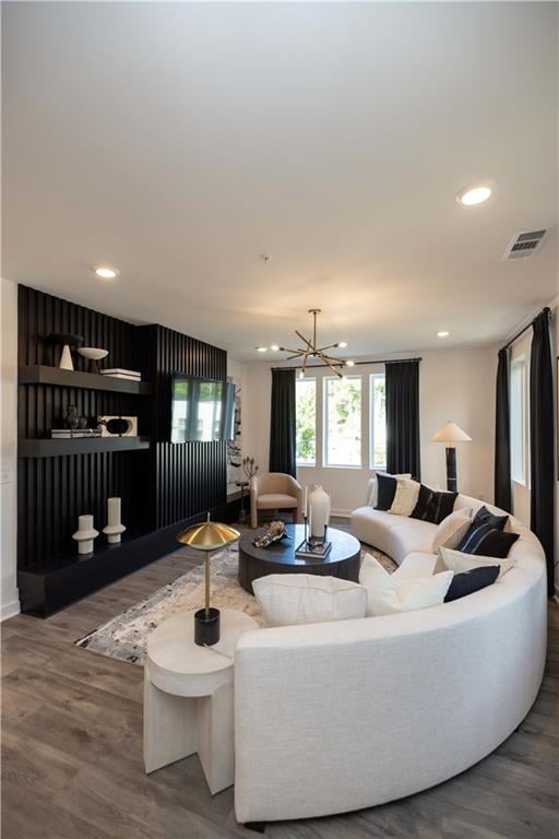 living room featuring hardwood / wood-style flooring and an inviting chandelier