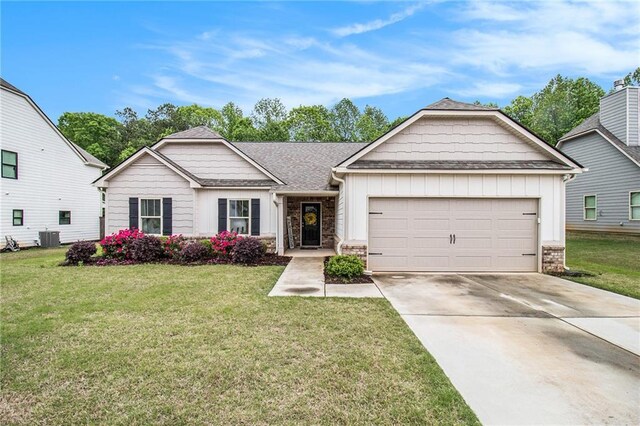 view of front of property with a garage, board and batten siding, concrete driveway, and a front yard