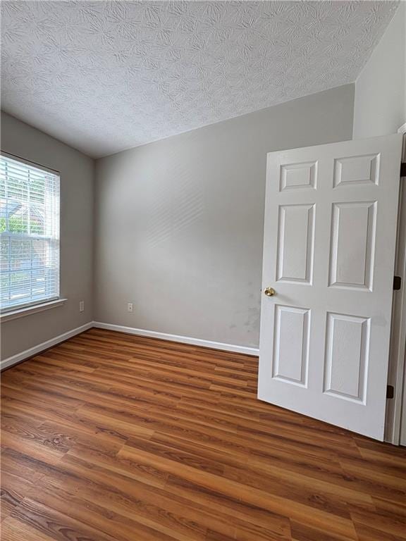 3884 Grovemont Pl, Duluth, GA 30096 - empty room featuring wood finished floors and a textured ceiling