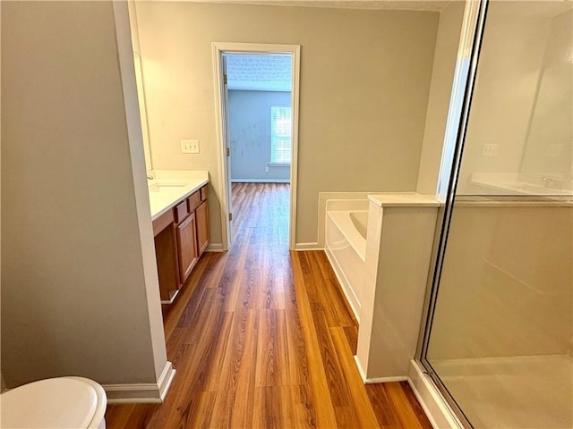3884 Grovemont Pl, Duluth, GA 30096 - bathroom with wood finished floors, vanity, a stall shower, and a bath