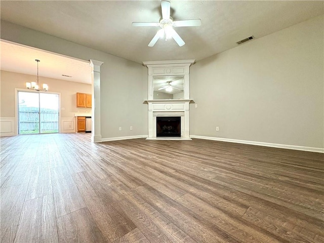 3884 Grovemont Pl, Duluth, GA 30096 - unfurnished living room with ceiling fan, wood finished floors, a large fireplace, and a chandelier