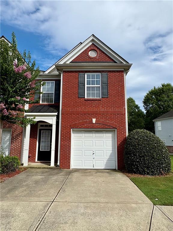 3884 Grovemont Pl, Duluth, GA 30096 - view of front of home with driveway, brick siding, and an attached garage