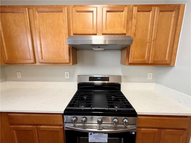 3884 Grovemont Pl, Duluth, GA 30096 - kitchen with stainless steel gas stove and wall chimney exhaust hood