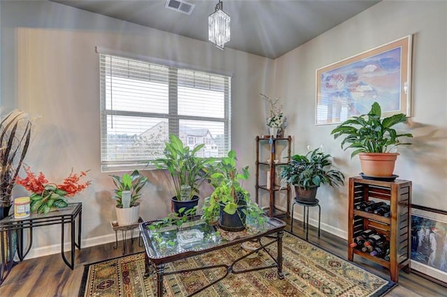 living area with a chandelier and hardwood / wood-style floors