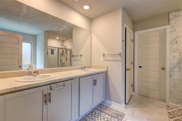 bathroom with vanity and a shower with shower door