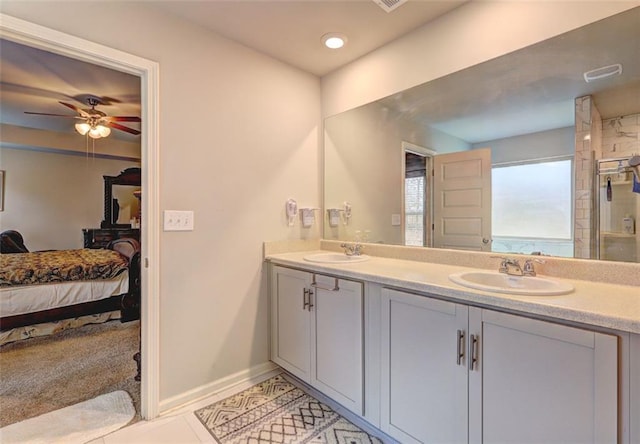 bathroom featuring ceiling fan, vanity, tile patterned floors, an enclosed shower, and a water view