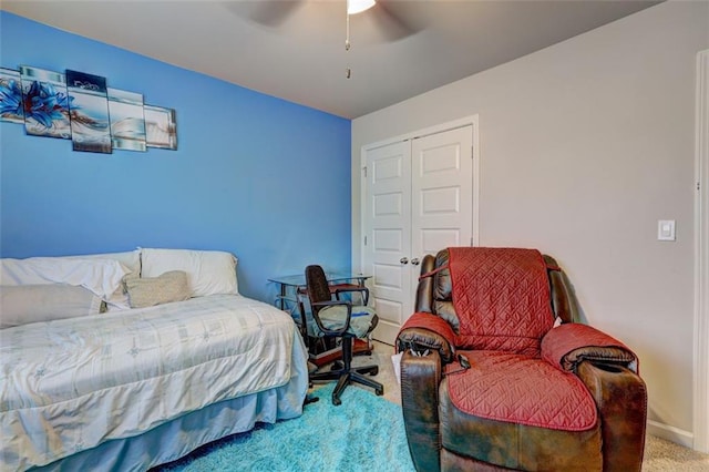 bedroom with ceiling fan, carpet floors, and a closet