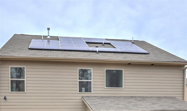 view of property exterior featuring solar panels