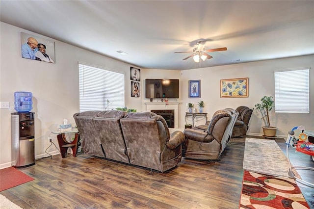 living room featuring dark hardwood / wood-style flooring and ceiling fan