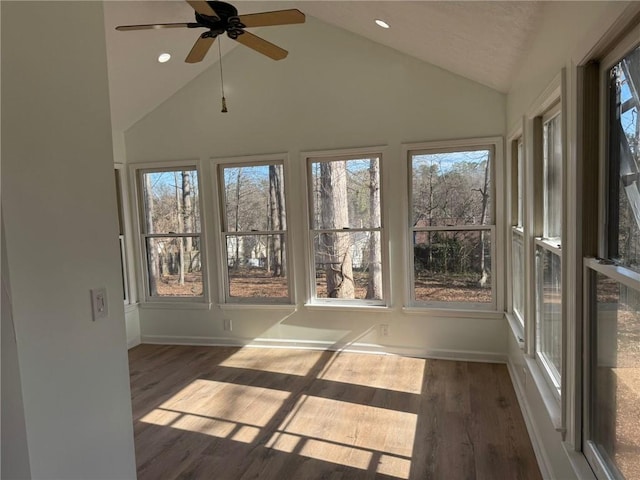 unfurnished sunroom featuring a ceiling fan and vaulted ceiling