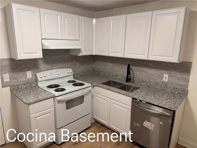 kitchen featuring stainless steel dishwasher, white electric range, under cabinet range hood, white cabinetry, and a sink