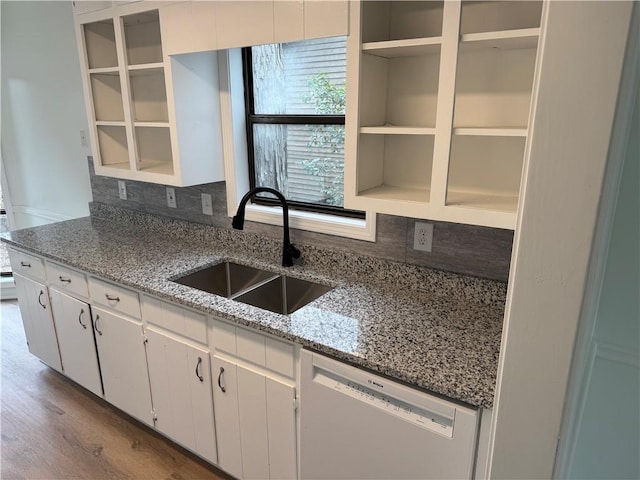 kitchen with dishwasher, wood finished floors, white cabinetry, open shelves, and a sink