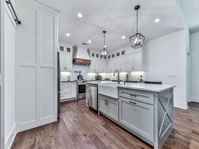 1170 Upper Sweetwater Trl SE, White, GA 30184 - kitchen with dark wood-type flooring, a sink, stainless steel appliances, and custom exhaust hood