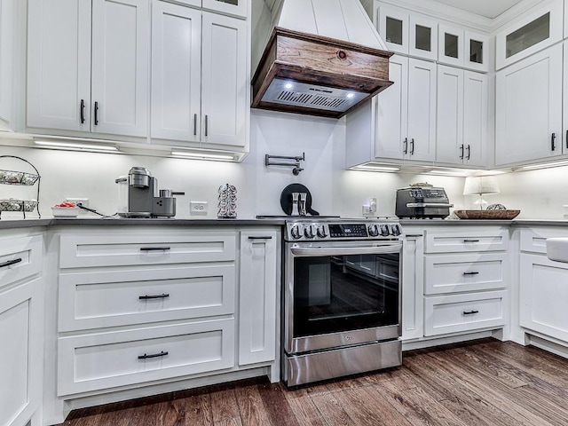 1170 Upper Sweetwater Trl SE, White, GA 30184 - kitchen featuring stainless steel range with electric stovetop, dark wood finished floors, glass insert cabinets, custom range hood, and white cabinets