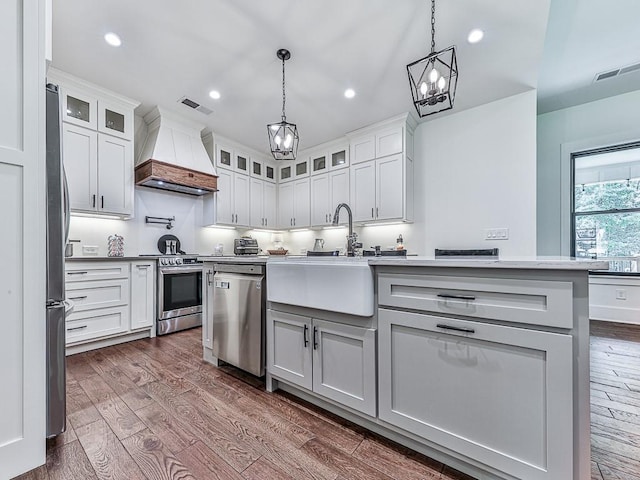 1170 Upper Sweetwater Trl SE, White, GA 30184 - kitchen with dark wood-style floors, visible vents, appliances with stainless steel finishes, and premium range hood