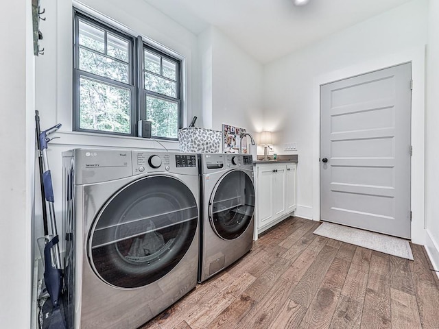 1170 Upper Sweetwater Trl SE, White, GA 30184 - clothes washing area featuring independent washer and dryer, a sink, cabinet space, and wood finished floors