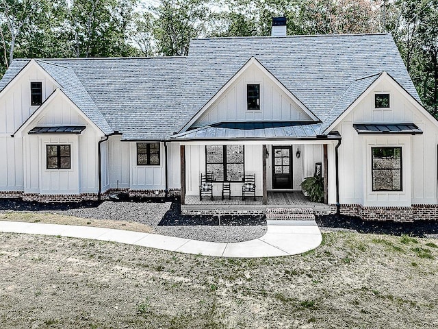 1170 Upper Sweetwater Trl SE, White, GA 30184 - modern inspired farmhouse featuring covered porch, a standing seam roof, board and batten siding, metal roof, and a shingled roof