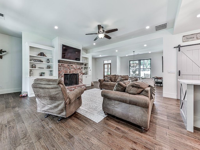 1170 Upper Sweetwater Trl SE, White, GA 30184 - living area with dark wood-style flooring, visible vents, baseboards, ceiling fan, and a barn door