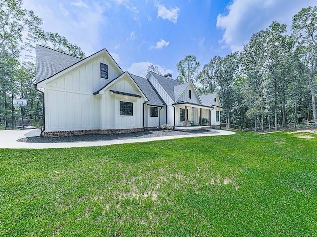 1170 Upper Sweetwater Trl SE, White, GA 30184 - rear view of property with a chimney, a shingled roof, board and batten siding, and a yard