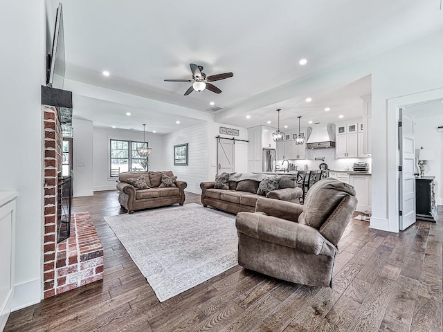 1170 Upper Sweetwater Trl SE, White, GA 30184 - living room featuring dark wood finished floors, ceiling fan with notable chandelier, visible vents, and recessed lighting