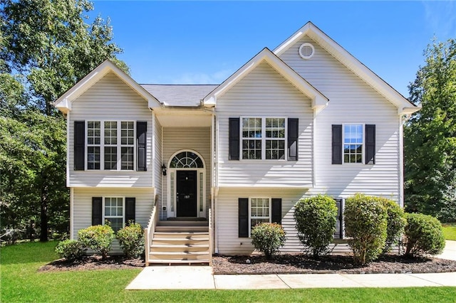 bi-level home with a front lawn