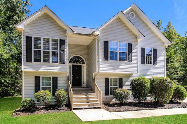 bi-level home with a front lawn