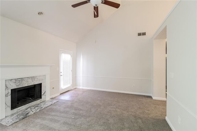 unfurnished living room featuring a high end fireplace, carpet, high vaulted ceiling, and ceiling fan