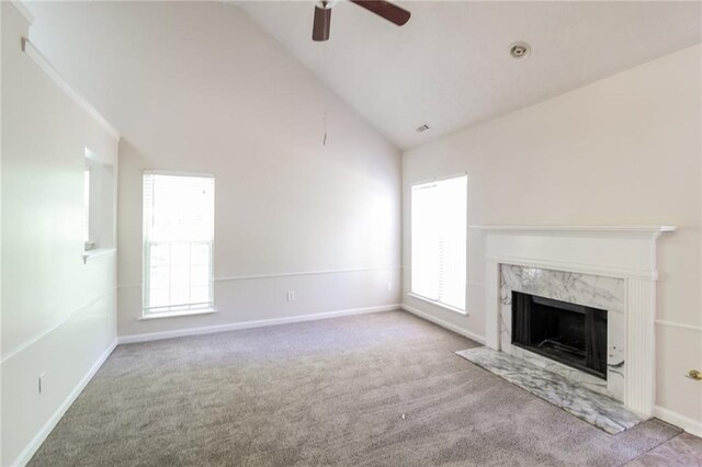 unfurnished living room with a wealth of natural light, carpet, and a fireplace