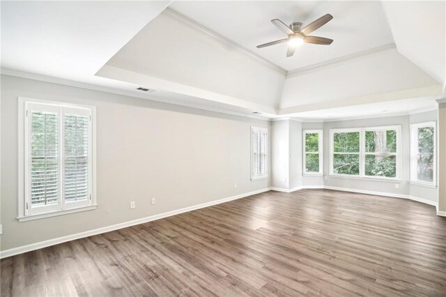 interior space featuring hardwood / wood-style flooring, crown molding, a tray ceiling, and ceiling fan