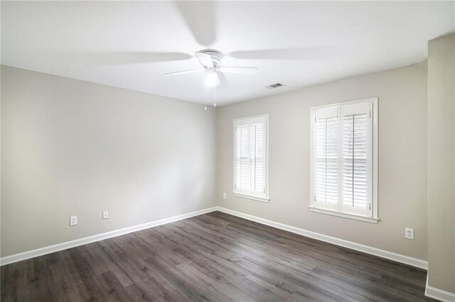 unfurnished room featuring ceiling fan and dark wood-type flooring