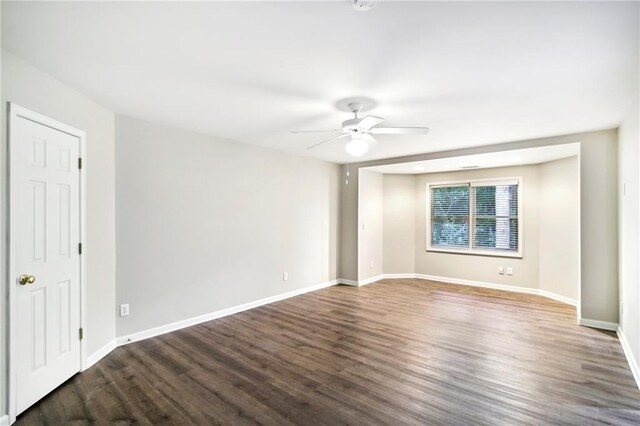 unfurnished room with ceiling fan and dark hardwood / wood-style flooring