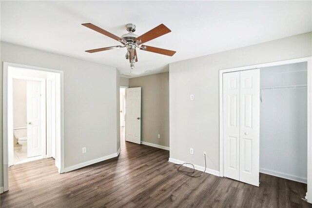 unfurnished bedroom featuring ceiling fan, dark hardwood / wood-style floors, a closet, and ensuite bathroom