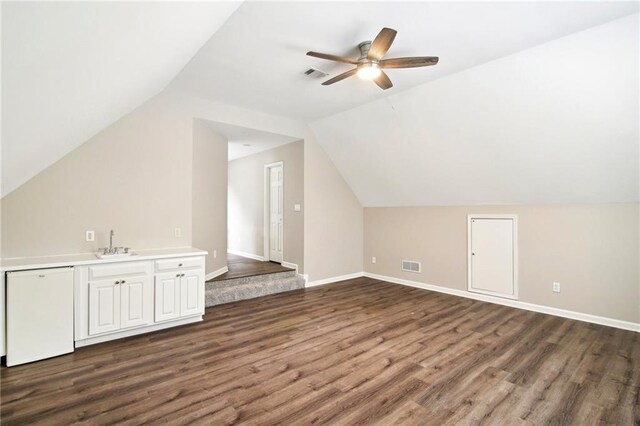 bonus room with ceiling fan, sink, dark wood-type flooring, and lofted ceiling