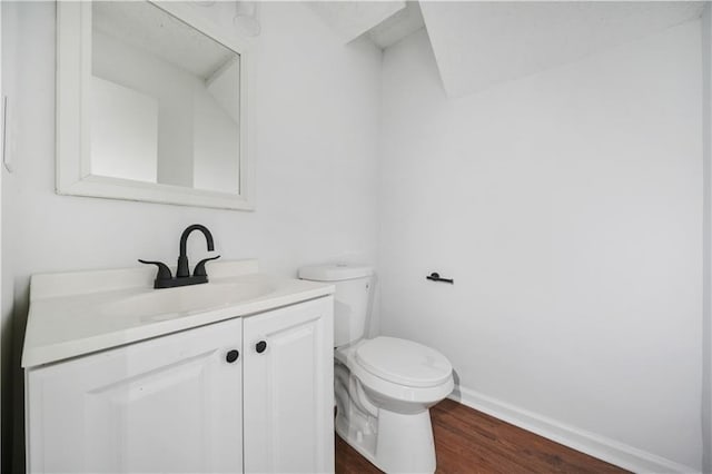 bathroom with vanity, baseboards, toilet, and wood finished floors