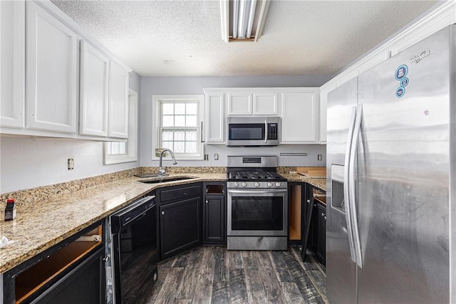 16 Bay Ct SW, Cartersville, GA 30120 - kitchen with stainless steel appliances, white cabinets, dark wood-style flooring, dark cabinetry, and a textured ceiling