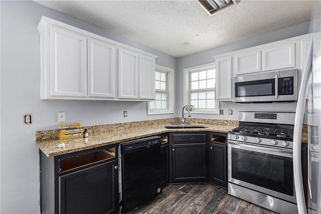 16 Bay Ct SW, Cartersville, GA 30120 - kitchen with appliances with stainless steel finishes, white cabinets, dark wood-style floors, dark cabinets, and a textured ceiling