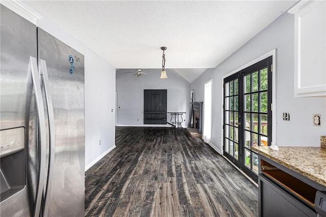 16 Bay Ct SW, Cartersville, GA 30120 - unfurnished dining area featuring dark wood-style floors, a fireplace with raised hearth, lofted ceiling, a ceiling fan, and french doors