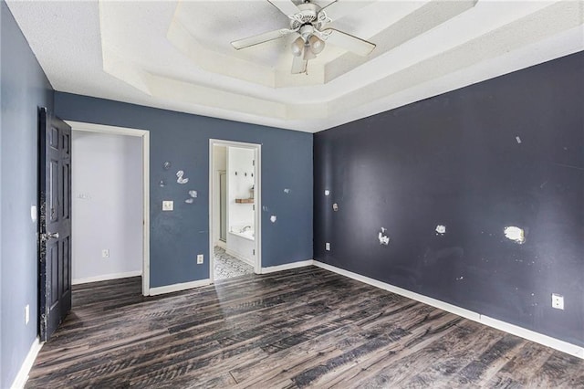 16 Bay Ct SW, Cartersville, GA 30120 - unfurnished bedroom featuring wood finished floors, a raised ceiling, ensuite bathroom, and ceiling fan