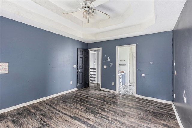 16 Bay Ct SW, Cartersville, GA 30120 - unfurnished room featuring a tray ceiling, wood finished floors, and ceiling fan