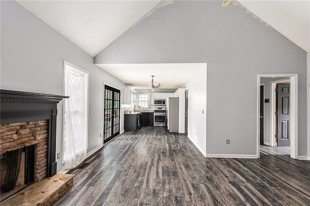 16 Bay Ct SW, Cartersville, GA 30120 - unfurnished living room with a fireplace with raised hearth, dark wood finished floors, and high vaulted ceiling