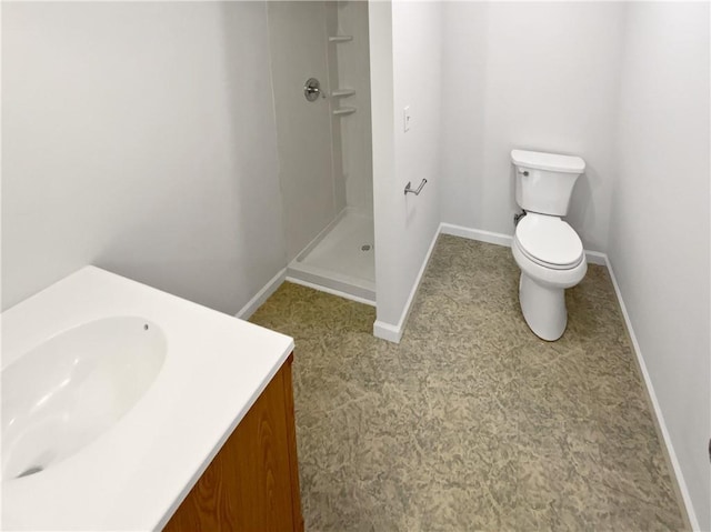 full bath featuring baseboards, toilet, a stall shower, and vanity