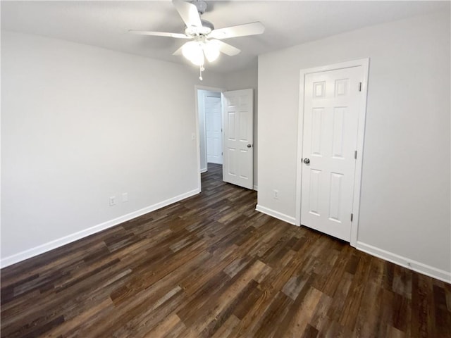 unfurnished bedroom featuring dark wood finished floors, baseboards, and ceiling fan