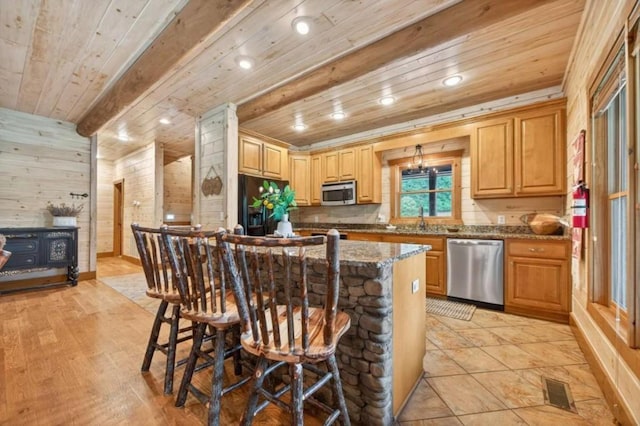311 Bailey Farm Ln, Mineral Bluff, GA 30559 - kitchen featuring stainless steel appliances, a wooden ceiling with exposed beams, a breakfast bar, dark stone counters, and wooden walls