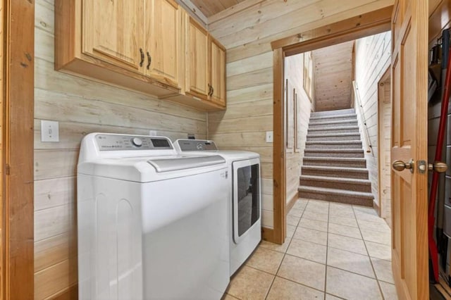 311 Bailey Farm Ln, Mineral Bluff, GA 30559 - laundry area with wooden walls, cabinet space, washing machine and dryer, and light tile patterned flooring