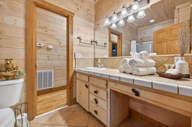 311 Bailey Farm Ln, Mineral Bluff, GA 30559 - full bathroom featuring wood walls, vanity, tile patterned flooring, an enclosed shower, and backsplash