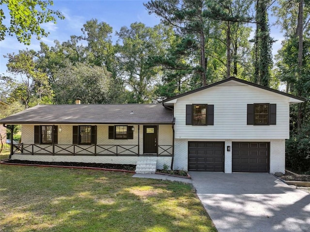 tri-level home featuring a garage and a front lawn